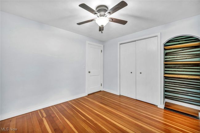 Unfurnished bedroom with a closet, hardwood flooring, and ceiling fan | Image 27