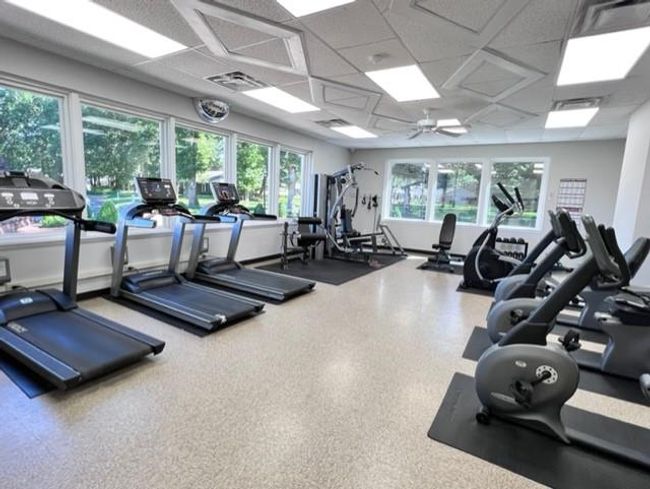 Gym with a paneled ceiling and a ceiling fan | Image 21