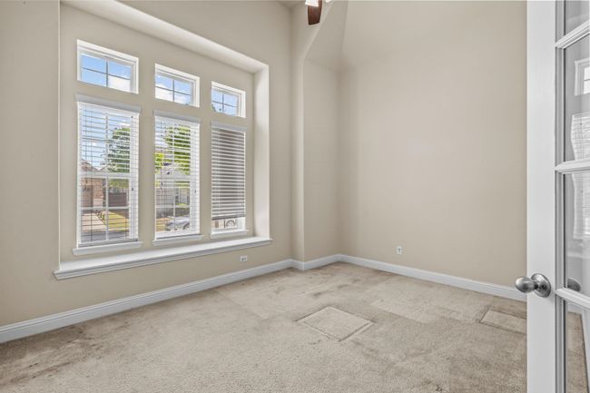 Empty room featuring carpet flooring, baseboards, and a ceiling fan | Image 6