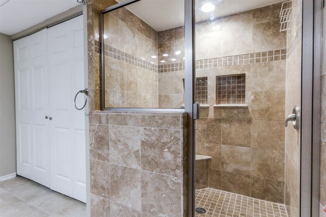 Bathroom with a shower stall and a closet | Image 9