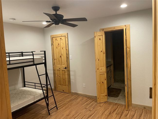 Bedroom with baseboards, light wood-type flooring, and recessed lighting | Image 28