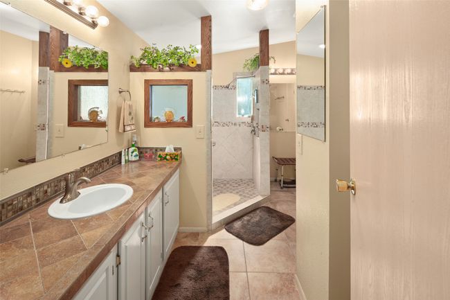 Bath with vanity, a shower stall, and tile patterned floors | Image 23