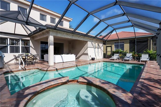 View of swimming pool with a pool with connected hot tub, a patio, and glass enclosure | Image 24