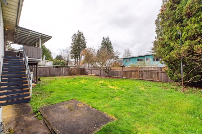 View of yard featuring stairs, a fenced backyard, and a wooden deck | Image 36
