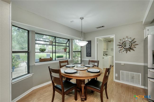 Breakfast area overlooking the large patio in the backyard. | Image 10