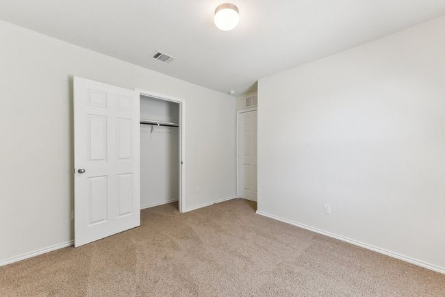 Unfurnished bedroom featuring carpet floors, baseboards, a closet, and visible vents | Image 27