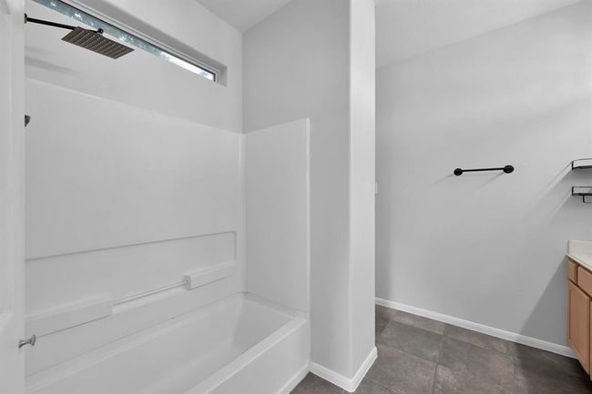 The upgraded rain showerhead features various flow settings. This bathroom and the remainder of the home are MOVE IN READY! | Image 21