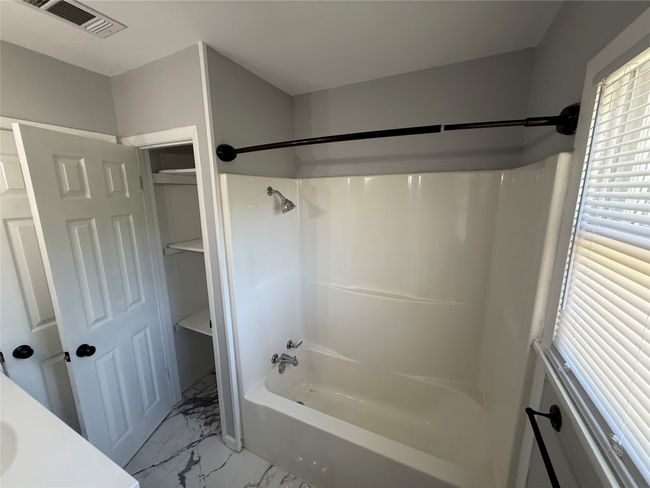Full bath with shower combination, and marble floor | Image 16