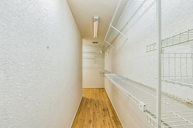 Walk in closet with wood finished floors and visible vents | Image 37