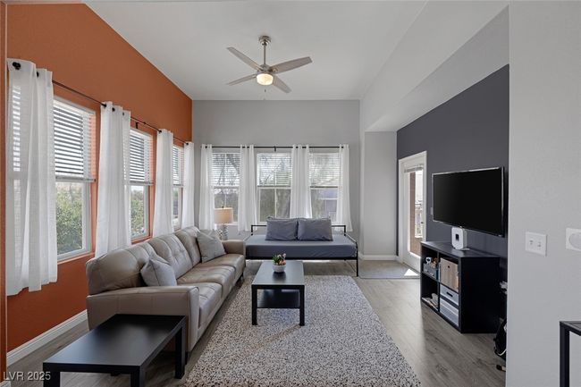 Living room with baseboards, a ceiling fan, and wood finished floors | Image 17