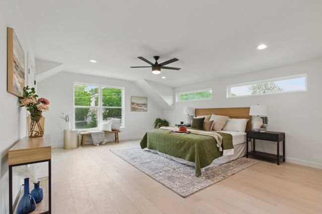 Bedroom with multiple windows, wood finished floors, baseboards, and recessed lighting | Image 14