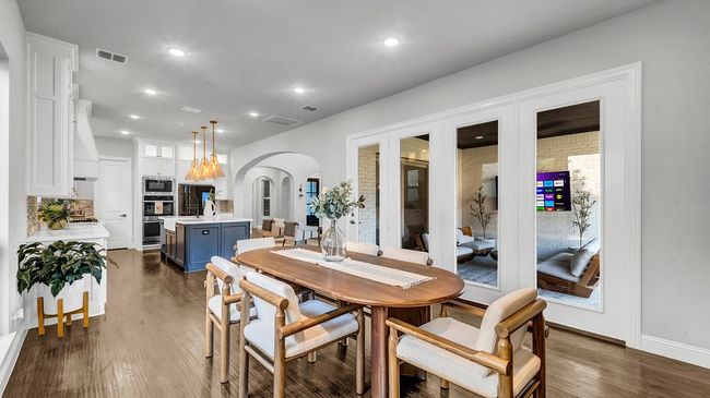 Dining space with visible vents, recessed lighting, arched walkways | Image 9