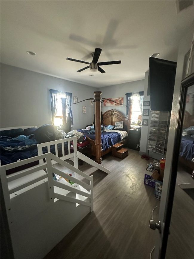 Bedroom featuring wood finished floors and ceiling fan | Image 38