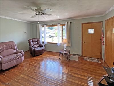 Living room featuring crown molding, ceiling fan, and wood-type flooring | Image 3