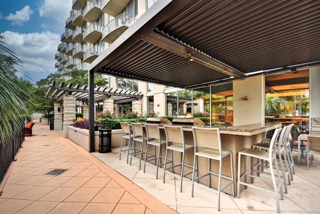 View of patio featuring a pergola and grilling area | Image 19