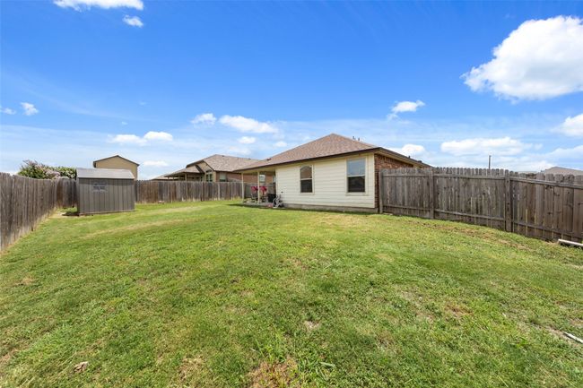 Fenced backyard featuring a shed | Image 17