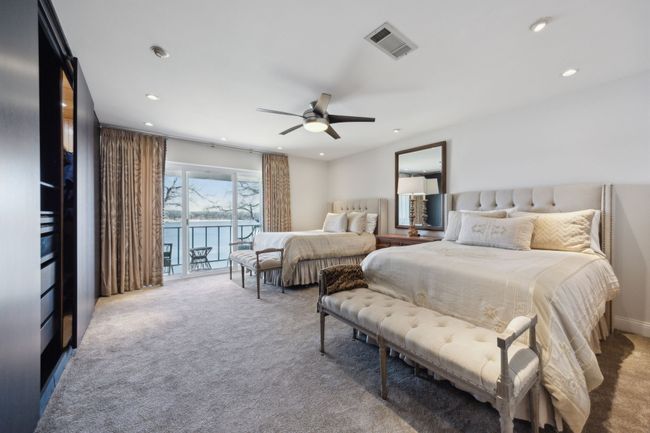 Lake views from large primary suite, balcony overlooking the lake and custom closet. | Image 23