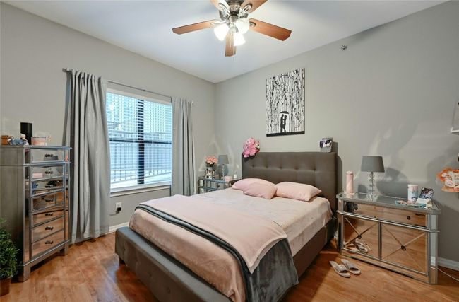 Bedroom featuring hardwood / wood-style floors and ceiling fan | Image 6