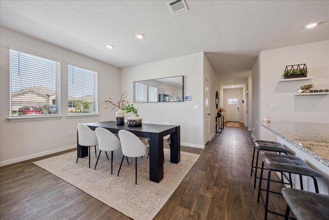 Dining space with healthy amount of natural light, dark wood-style floors, and recessed lighting | Image 12