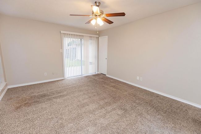 Unfurnished room with ceiling fan, carpet, and baseboards | Image 17