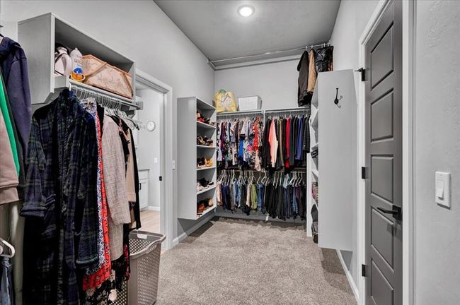 Walk in closet featuring carpet floors | Image 34
