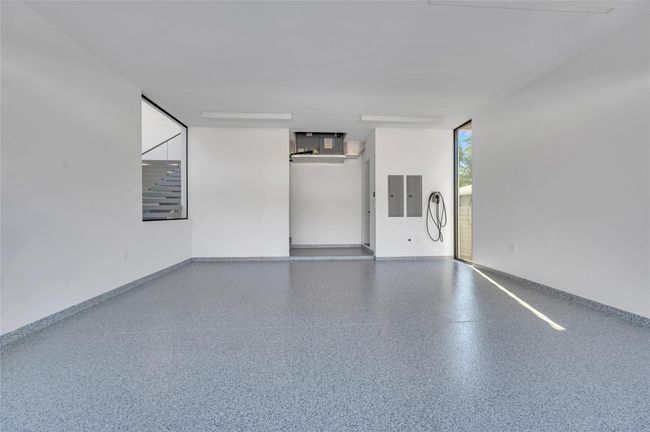 Viewing Window from the interior of the home into the garage, perfect for car enthusiasts. | Image 58