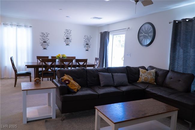 Living area featuring ceiling fan, visible vents, and carpet | Image 34