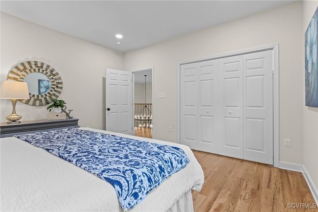 Bedroom with light wood finished floors, a closet, and recessed lighting | Image 32