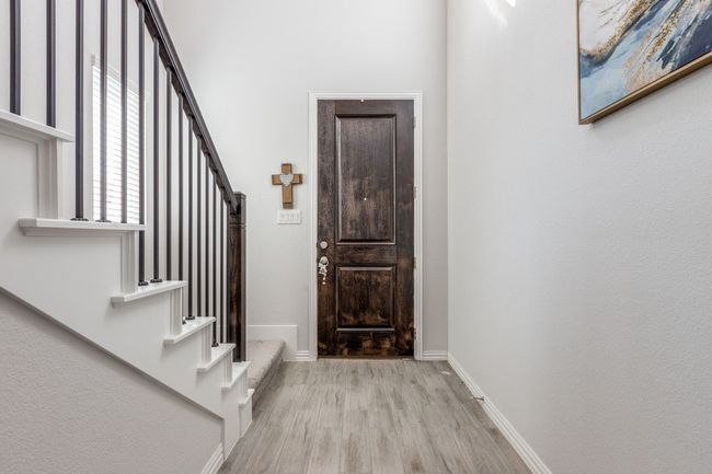 Entryway with wood finished floors, stairs, and baseboards | Image 4
