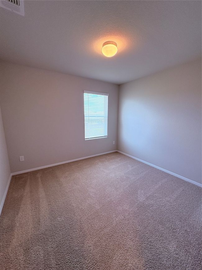 Unfurnished room with baseboards, visible vents, and light colored carpet | Image 23