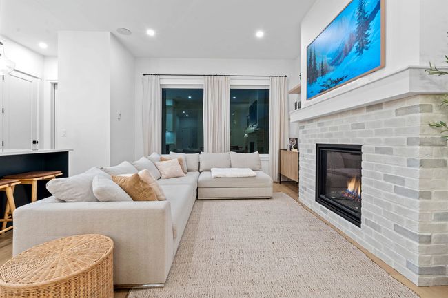 Living room with recessed lighting, a fireplace, and wood finished floors | Image 9