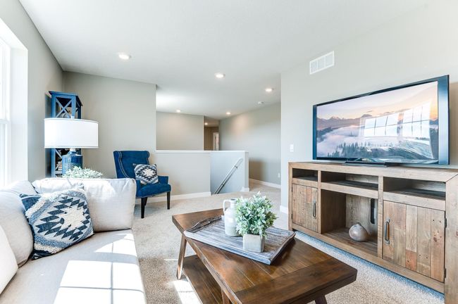 The entire level flows from the focal point offered by this huge loft space. Sure to become a family favorite hangout spot, the room is just steps from each of the home's three upper level bedrooms! Photo of model home, color & options will vary. | Image 22