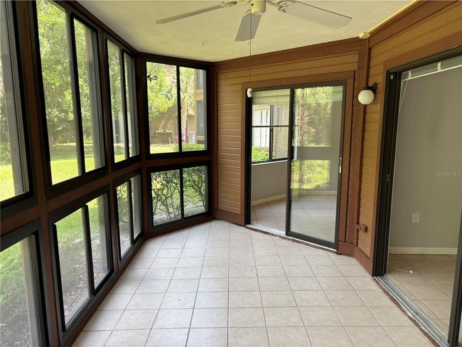 View towards primary bedroom from screened lanai | Image 6