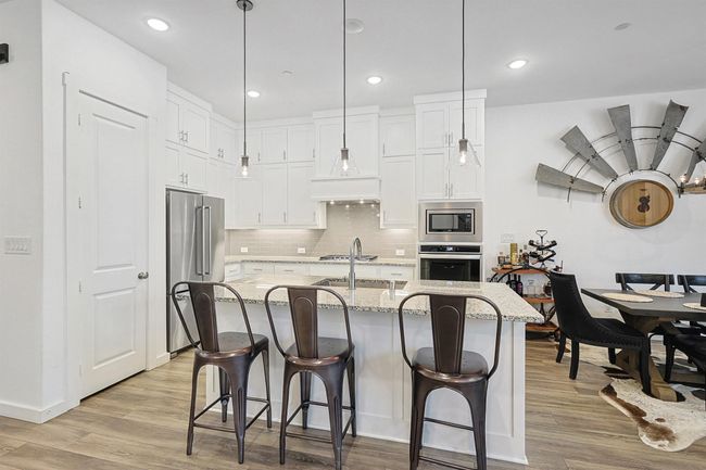 Breakfast bar, pantry, granite counters and gas cook top | Image 7