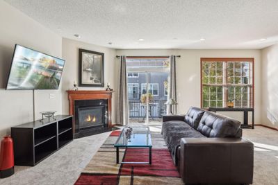 The living room has a corner gas fireplace and this will be a very delightful place for all those chill days to come. You would definitely enjoy the fireplace as you watch the snow falling and someone else shoving all of that snow. | Image 3