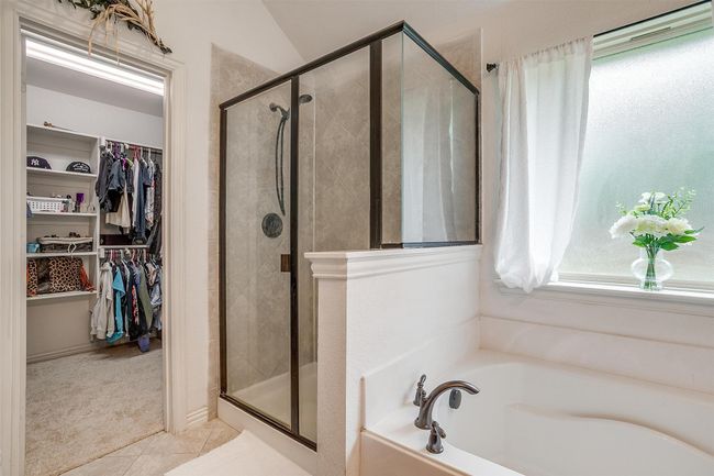 Bathroom with a garden tub, a spacious closet, a shower stall, and tile patterned floors | Image 22