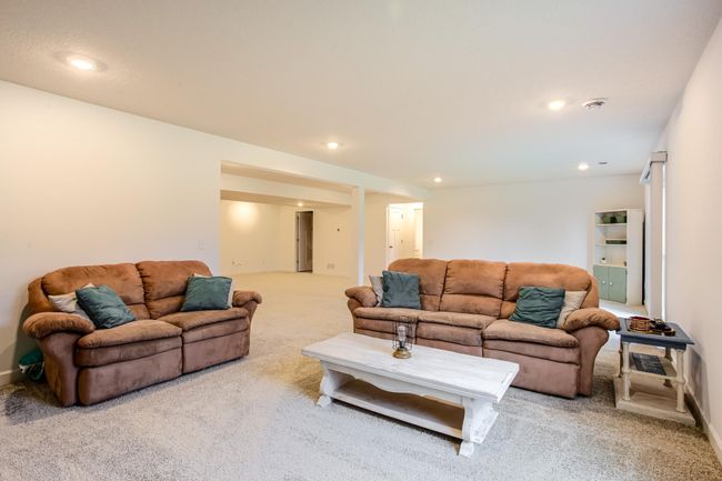 A spacious open-concept design offers seamless flow for both lounging and play. | Image 34