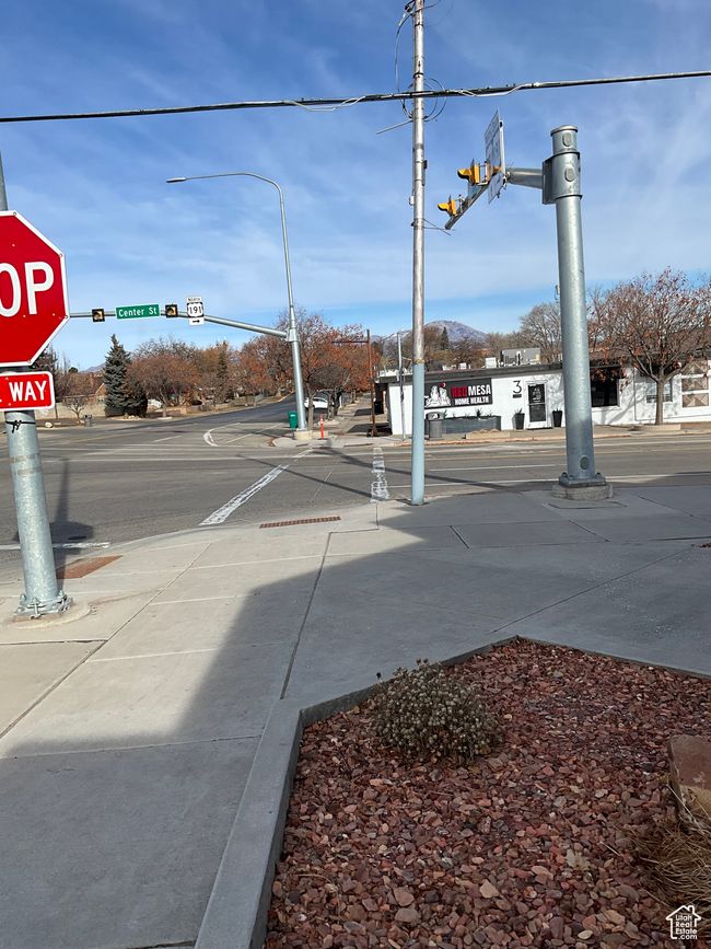 View of street with traffic signs, sidewalks, and traffic lights | Image 5