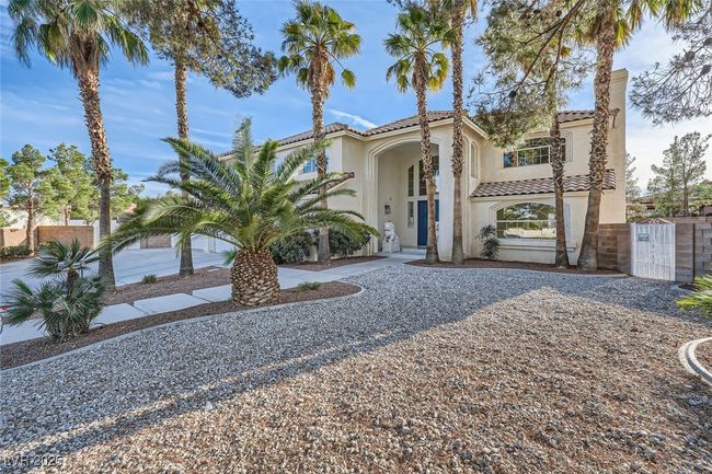 Mediterranean / spanish-style house featuring a gate, a tile roof, and stucco siding | Image 19