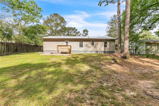 Back of house featuring a yard, crawl space, and fence | Image 38