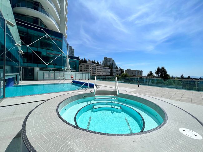 Community pool with a city view, fence, a community hot tub, and a patio area | Image 22