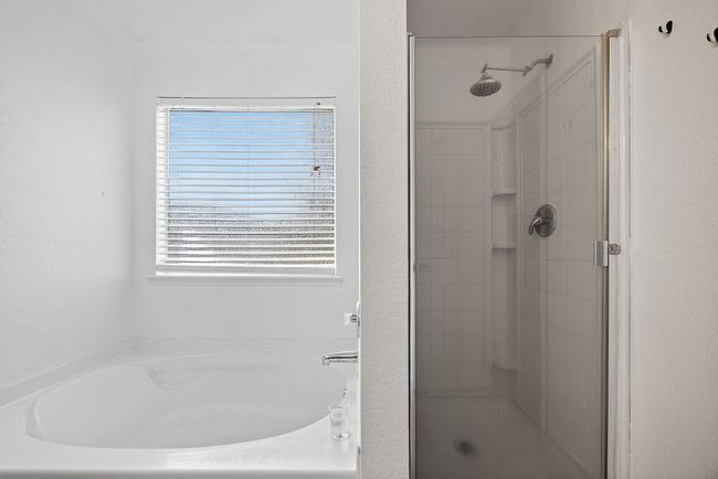 Full bathroom with a stall shower and a bath | Image 24