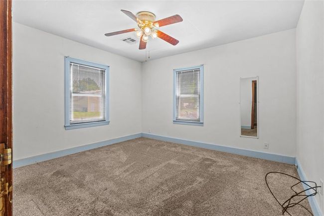 Unfurnished room with ceiling fan and carpet flooring | Image 16