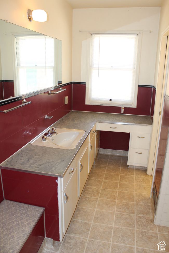 Bathroom featuring healthy amount of natural light, vanity, and tile patterned floors | Image 33