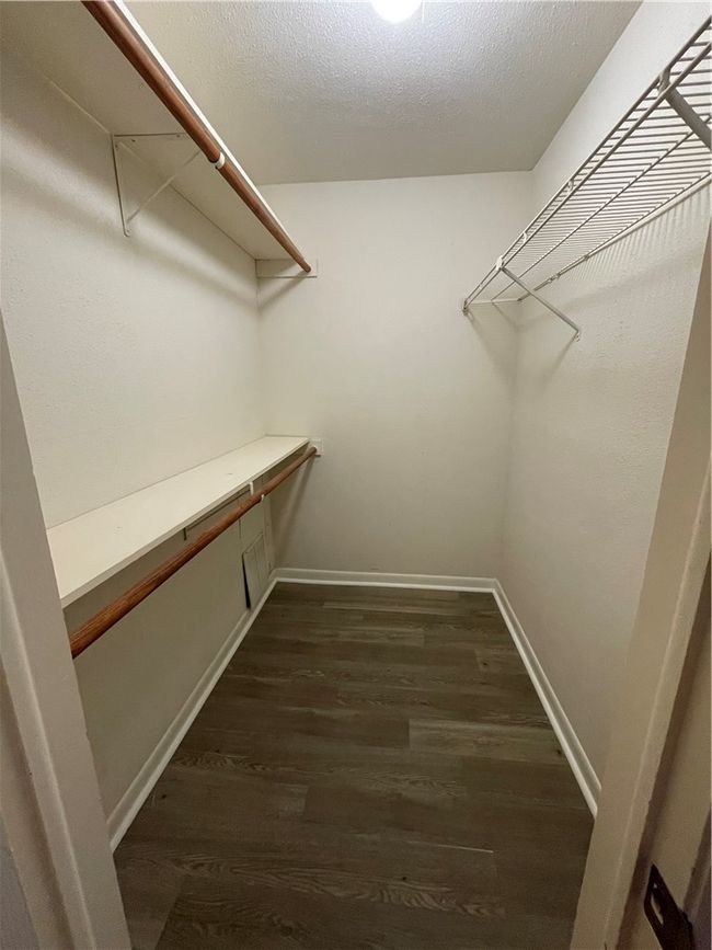 Spacious closet featuring dark hardwood / wood-style floors | Image 9