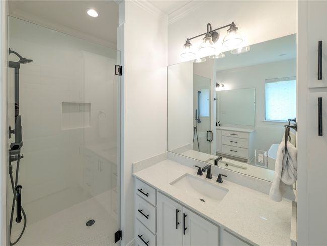 Bathroom with ornamental molding, a stall shower, vanity, and recessed lighting | Image 21