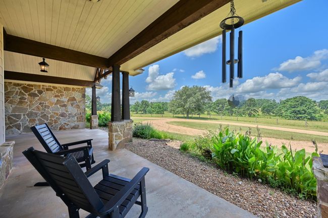 Enjoy peaceful countryside views from the front porch. | Image 32