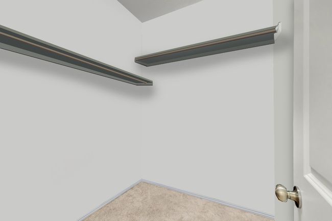 Walk in closet featuring light colored carpet | Image 21