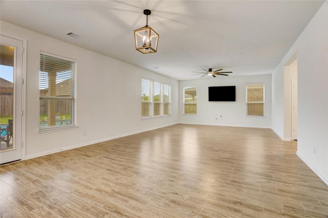 The large great room that combines a spacious dining area and living room. | Image 9