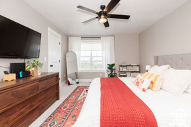 Carpeted bedroom featuring a ceiling fan and baseboards | Image 9